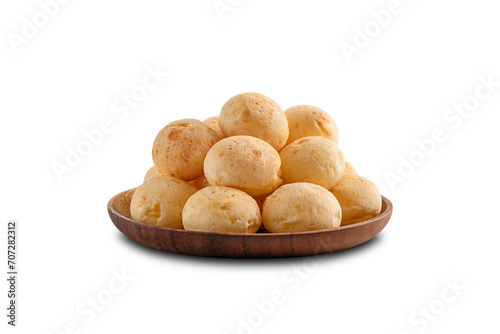 Cheese Breads pile on wooden plate. Brazilian snack. Isolated on white background.