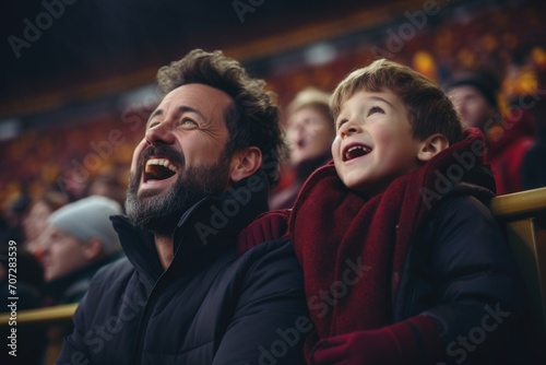 Father and son cheering in football stadium
