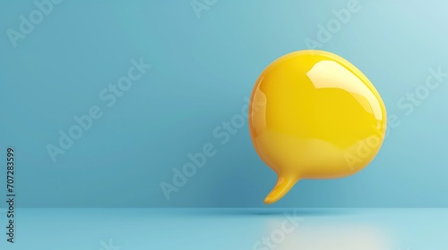 yellow plastic soft speech bubble against blue background. photo