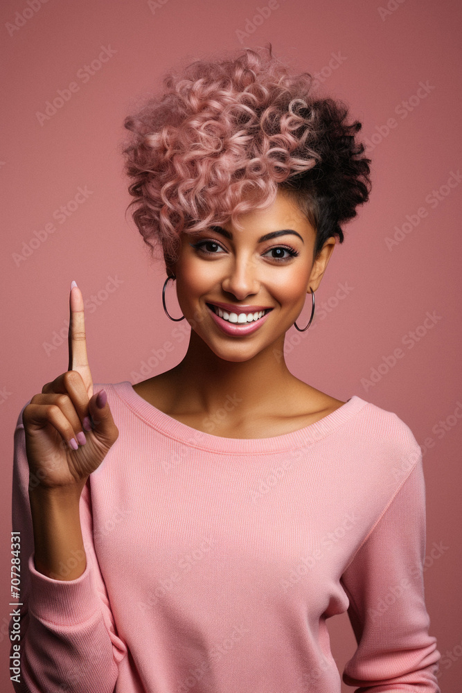 Young african american woman with pink curly hair pointing at copy space Young african american woman with pink curly hair pointing at copy space