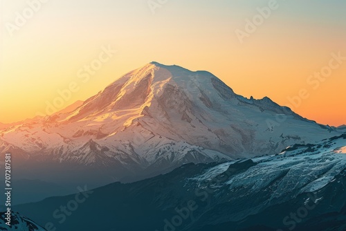 A beautiful snow covered mountain illuminated by the warm colors of the sunset. Ideal for nature and landscape enthusiasts