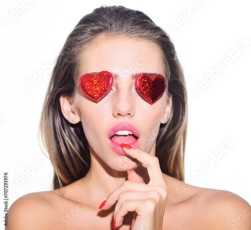 Valentine's day celebration. Love symbol. Sexy girl with red hearts on eyes. Romantic mood. Closeup portrait of sensual woman with valentines hearts on eyes. Valentines day party. Love and romance.