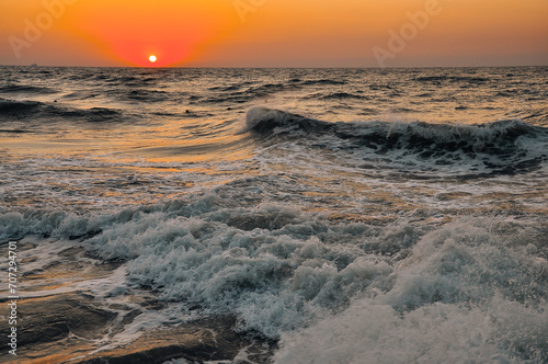 Fototapeta Naklejka Na Ścianę i Meble -  Raging sea waves at sunset in the ocean. Storm clouds on the sea.