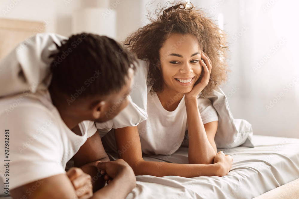 Loving Black Spouses Smiling Enjoying Romantic Morning In Bedroom