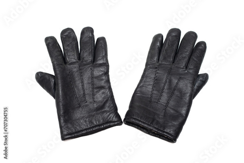 Old black leather warm gloves on a white background.