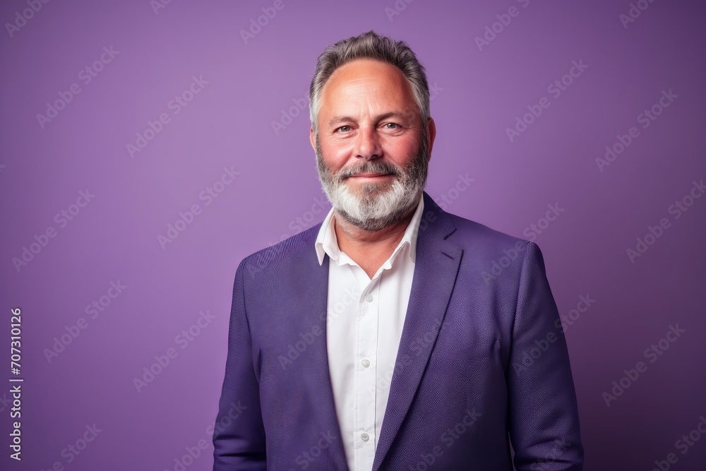 Handsome middle age man with grey beard and mustache in a purple suit. Handsome middle age man with grey beard and mustache in a purple suit.