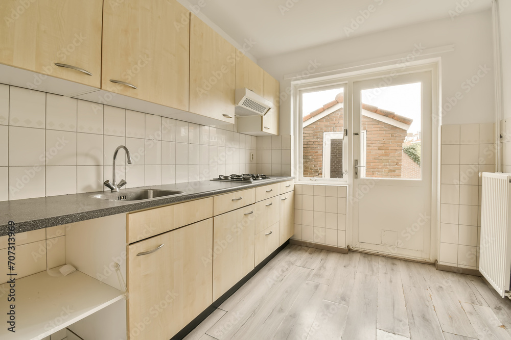 a kitchen with wooden cabinets and a window a kitchen with wooden cabinets and a window