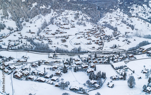 Aerial panorama view of Grindelwald villages with wooden chalets covered with snow in cold winter season in Swiss Alps