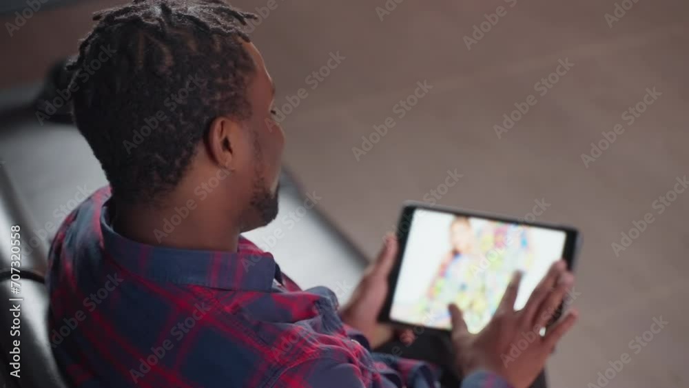 male internet user shopping online on website of clothes store, viewing pictures on tablet display male internet user shopping online on website of clothes store, viewing pictures on tablet display