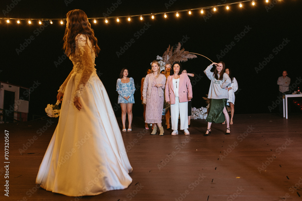 bride in a white dress throws a wedding bouquet bride in a white dress throws a wedding bouquet