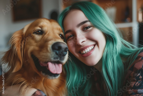 Green haired young adult woman with her golden retriever dog in a living room