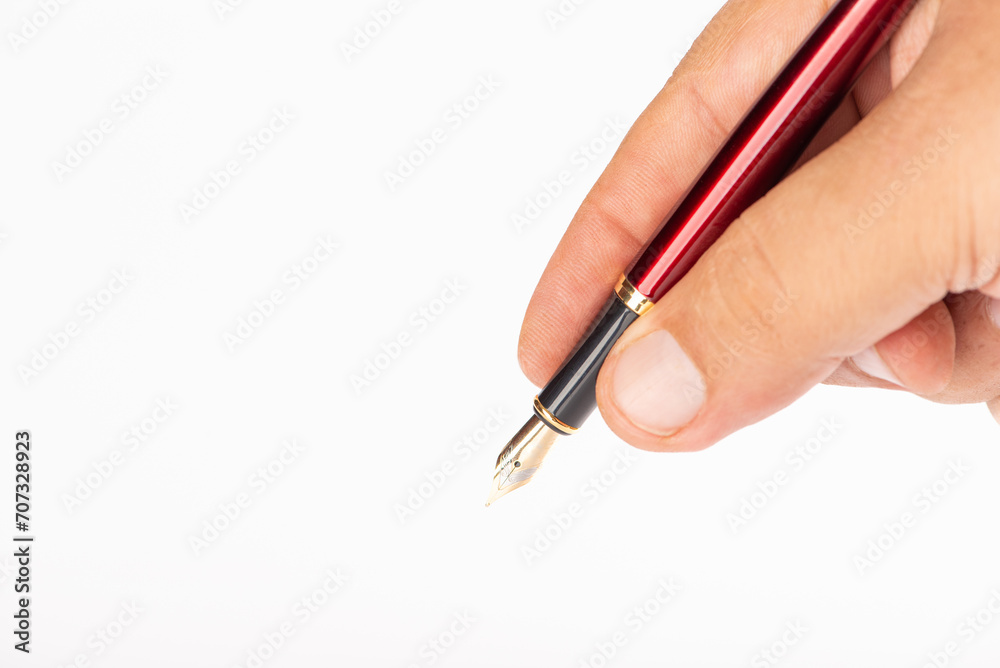 Fountain pen and hand, beautiful fountain pen in detail held in hand, with white background, selective focus. Fountain pen and hand, beautiful fountain pen in detail held in hand, with white background, selective focus.