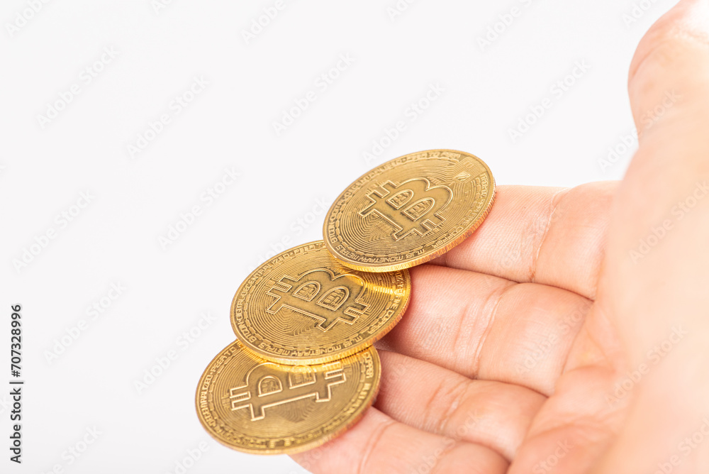 Bitcoin, hand holding bitcoin coins, with white background, selective focus. Bitcoin, hand holding bitcoin coins, with white background, selective focus.