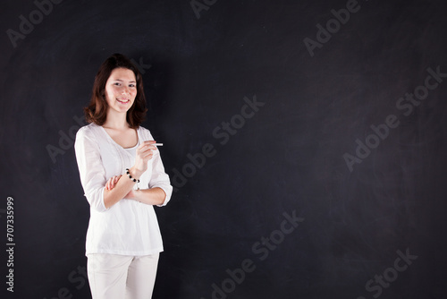 a woman standing in front of a blackboard