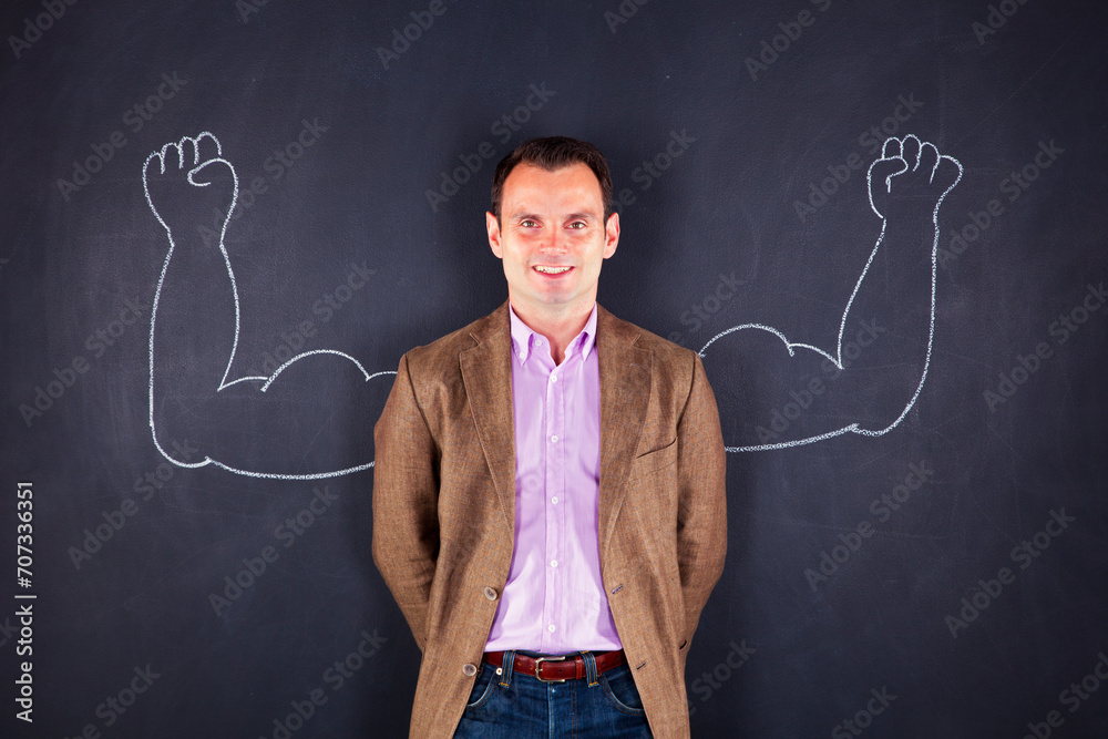 a man proudly stands beside a drawing of muscular arms