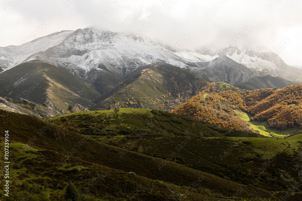 Panoramic landscape of natural park in northern Spain Cantabrian mountain range with peaks and autumn forest on a cloudy overcast day