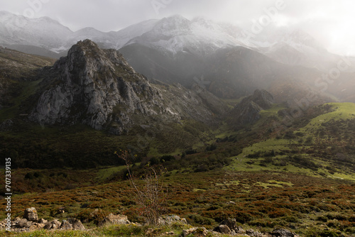 Cloudy landscape of Las Ubinas la Mesa natural park in Astuarias with dramatic clouds and sunny panoramic view of meadow photo