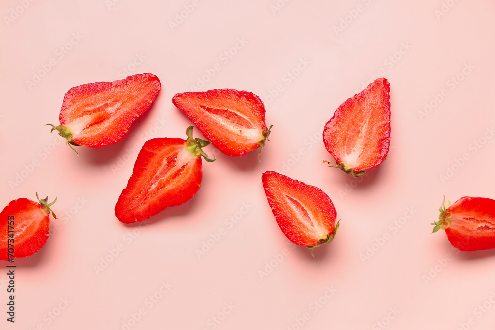 Slices of fresh strawberries on pink background Slices of fresh strawberries on pink background