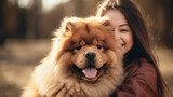 Young female dog owner, hugging chow chow dog