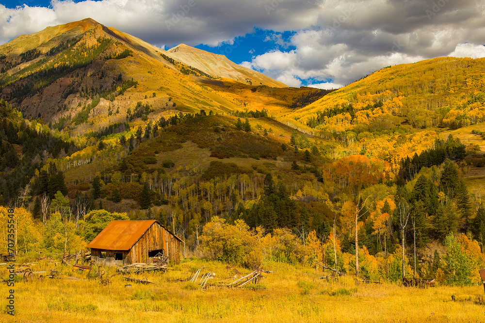 Shack at the foot of hills in San Juan Mountains in the Fall