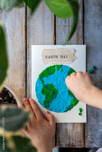 Concept of educational ecological programs for kindergarten and school. Making craft handmade postcard for the earth day. Teaching conscious sustainable lifestyle to children. Handicraft