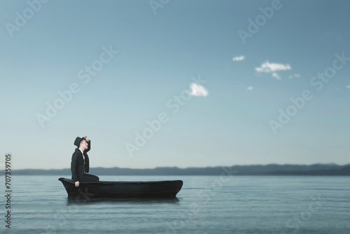 lonely man sailing lost in a small boat in the middle of the sea looking for himself