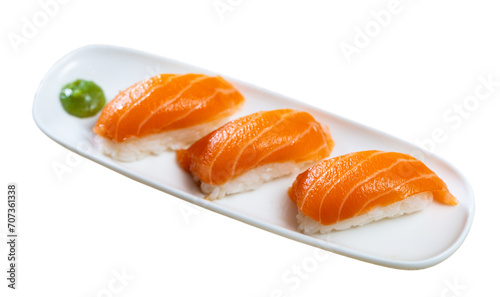 Japanese sushi sake nigiri with raw salmon served on platter. Isolated over white background