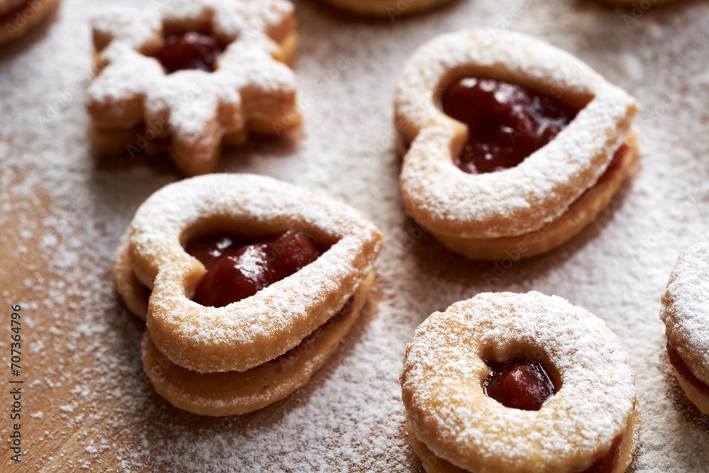 Heart shaped Linzer Christmas cookies filled with strawberry marmalade