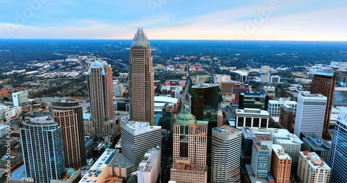Drone approaching the group of high-rise buildings built close to each other in the city downtown. View of North Carolina, USA from aerial perspective. photo