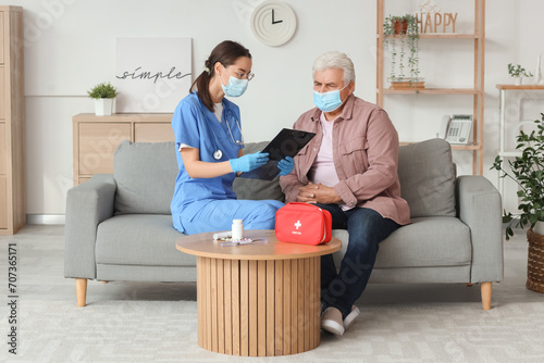 Senior man and nurse with c...