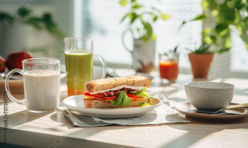 Breakfast with sandwiches and juice on the table in the morning.