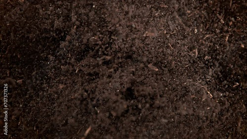 Super Slow Motion Shot of Exploding Soil Towards Camera at 1000fps. photo
