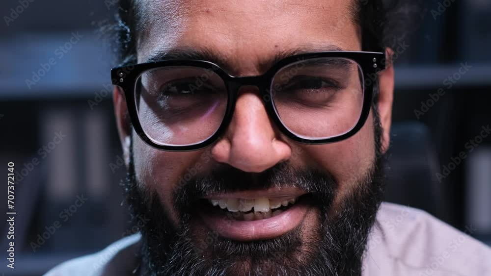 In a captivating close-up, an positive Indian businessman in eyeglasses, dressed professionally, smiles warmly into the camera, radiating confidence and approachability. In a captivating close-up, an positive Indian businessman in eyeglasses, dressed professionally, smiles warmly into the camera, radiating confidence and approachability.