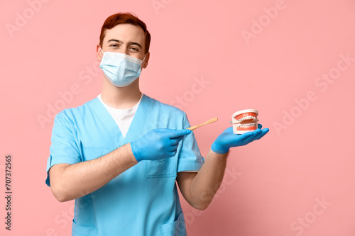 Male dentist in mask with t...