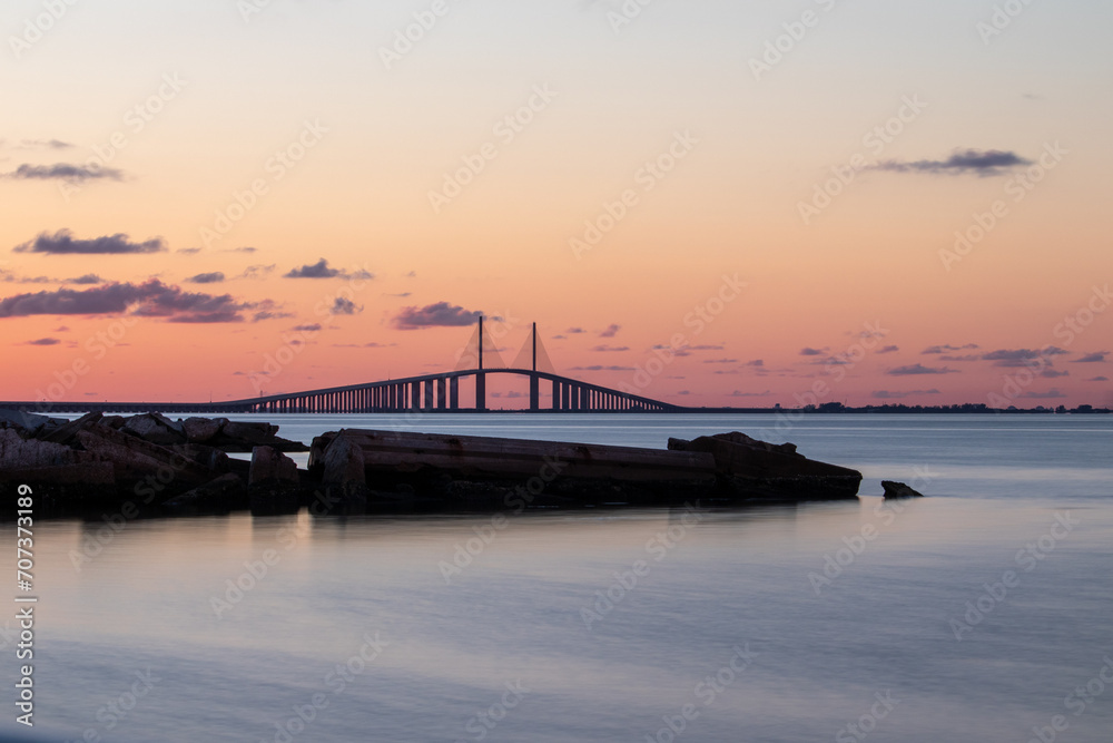 Sunset hues over the Sunshine Skyway Bridge with calm waters. Sunset hues over the Sunshine Skyway Bridge with calm waters.
