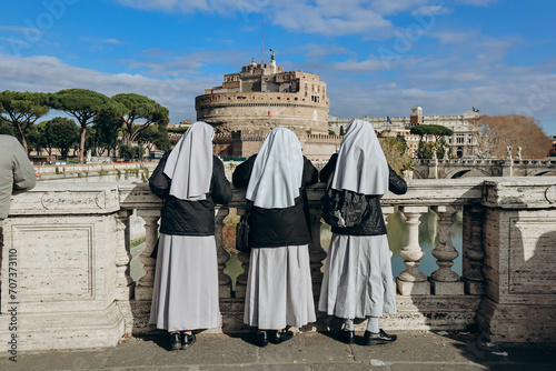 Nuns on the Ponte Vittorio Emanuele II look at Rome and Castel Angelo photo