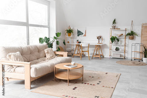 Interior of living room with sofa  plants and workplace