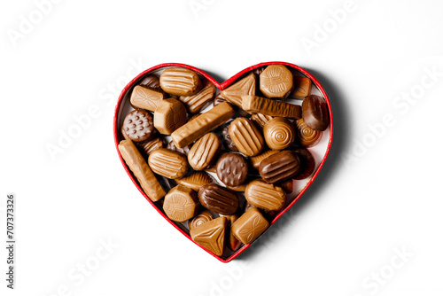 Valentine's Day chocolate candies in red heart shaped box isolated, white background. © Inga