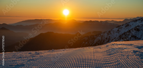 Freshly groomed ski slope photo