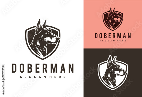Leinwand Poster doberman dog logo with shield design vector illustration