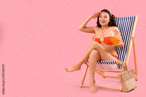 Young woman in orange bikin...