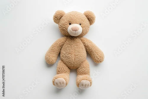 Flat lay of soft toy bear on white background