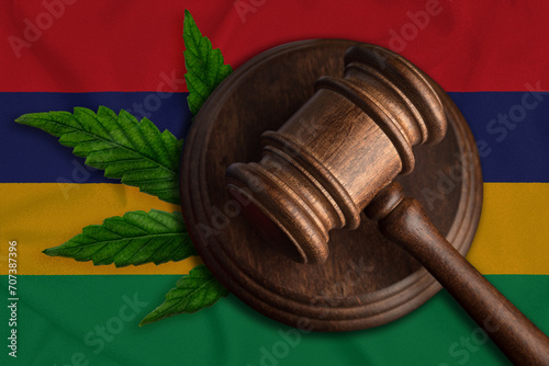 Judicial wooden gavel, fresh hemp leaf and Mauritus flag. Illegal sale and distribution of marijuana