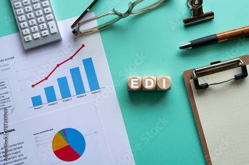 There is wood cube with the word EDI. It is an abbreviation for Electronic Data Interchange as eye-catching image. photo