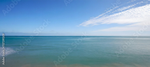 Tranquil Sea and Wispy Clouds © arber.design