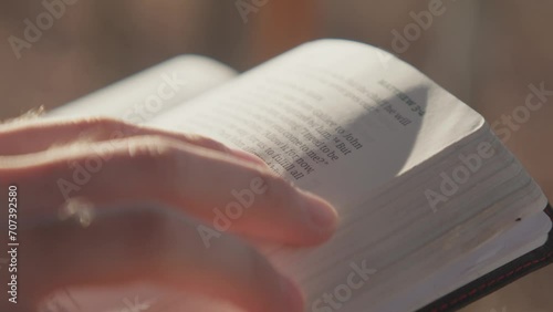 Macro shot of hands studying scripture and holding the Bible 