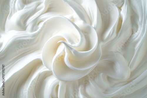 Whipped cream swirling on white background photo