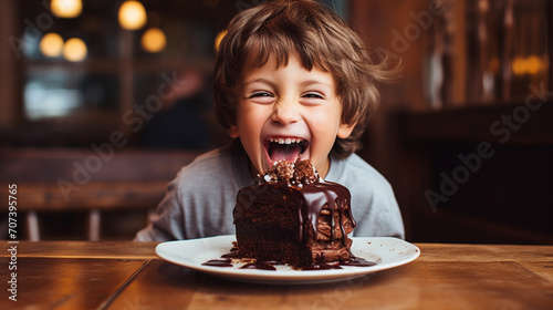 happy child eats chocolate cake. photo