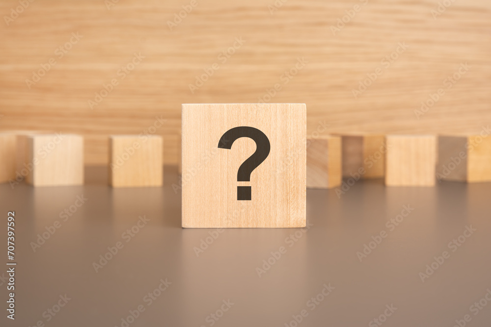 wooden cube questions signs on its sides. concept of choosing the right solution wooden cube questions signs on its sides. concept of choosing the right solution