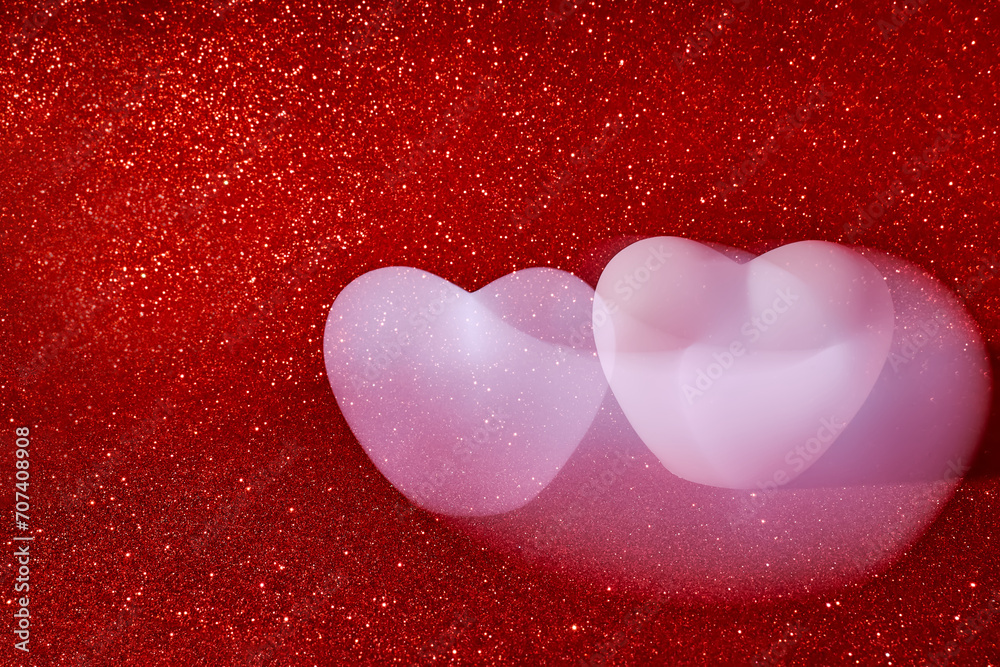 Abstract photography of two pink heart in attraction motion , making with long exposition on red glittering background.